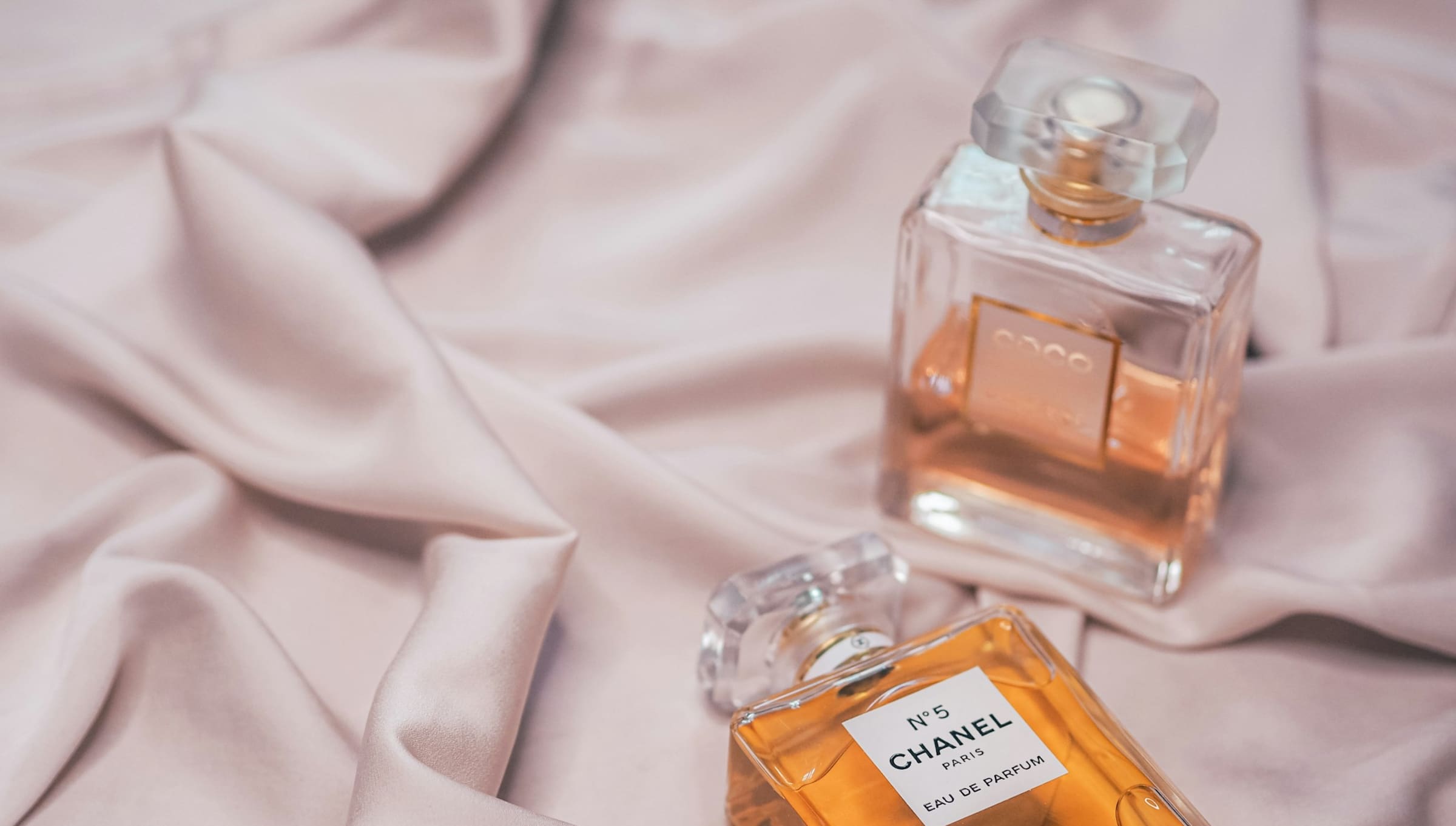 Chanel bottles on bed